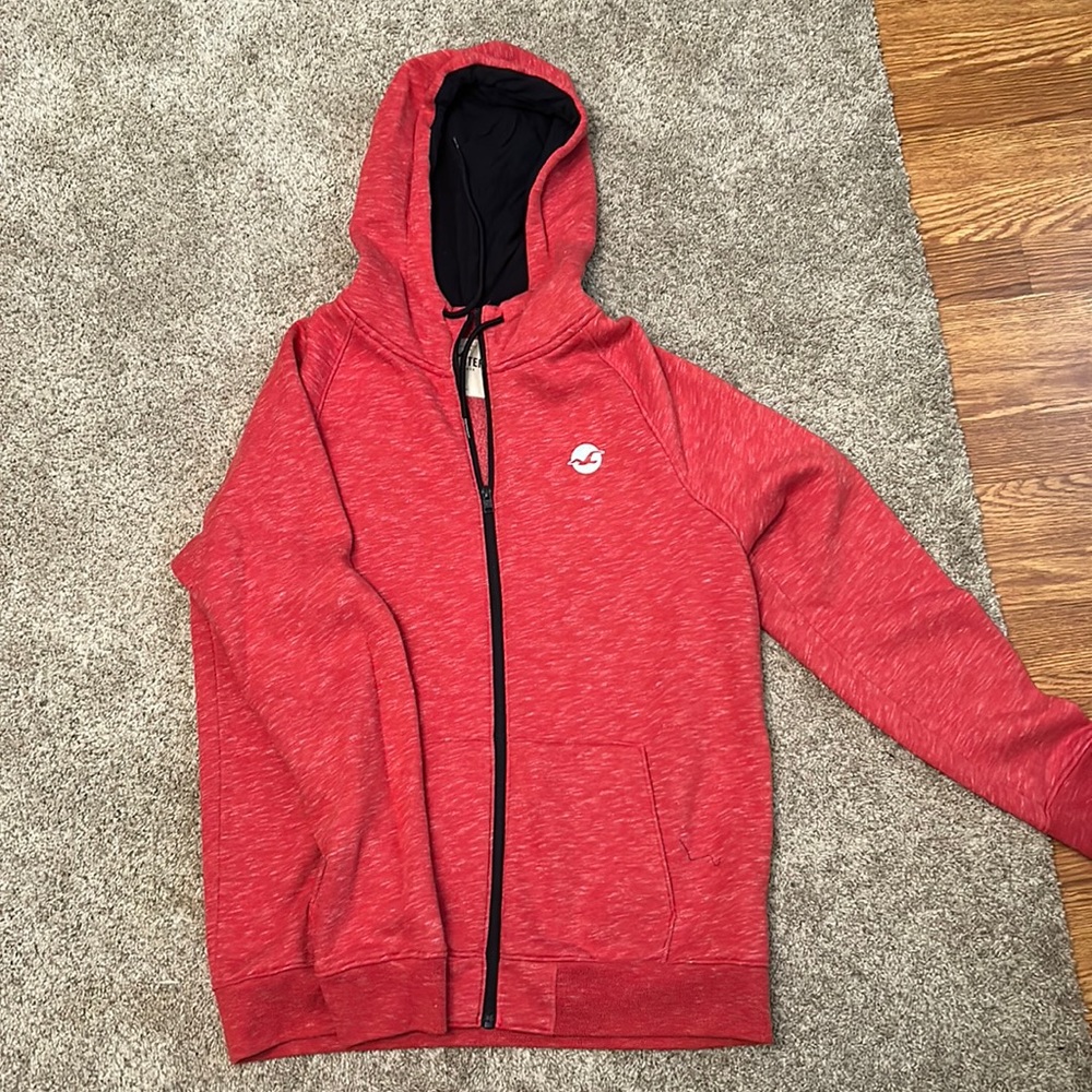This is a Hollister red zip up hoodie. Men’s Large